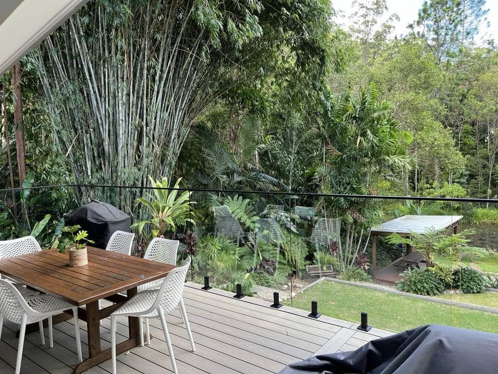 Frameless glass balustrade on a timber deck with black mini posts